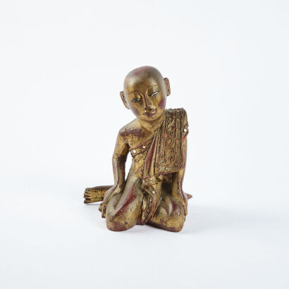 A Gilded South East Asian Kneeling Buddha Figure