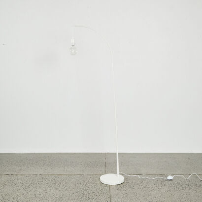 A Minimal White Arched Floor Lamp with Edison Bulb