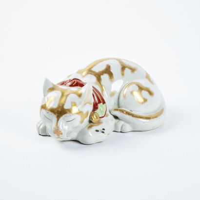 A Japanese Porcelain Figure Of A Sleeping Cat