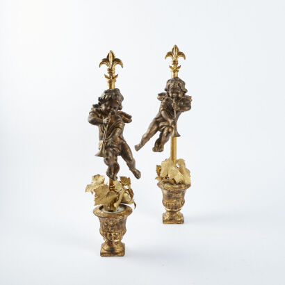 A Pair Of Garden Ornaments With Cherubs