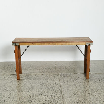 An Industrial Side Table With Folding Legs