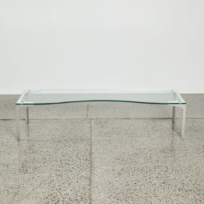 A Contemporary Curved Front Glass Coffee Table With Cast Aluminium Legs