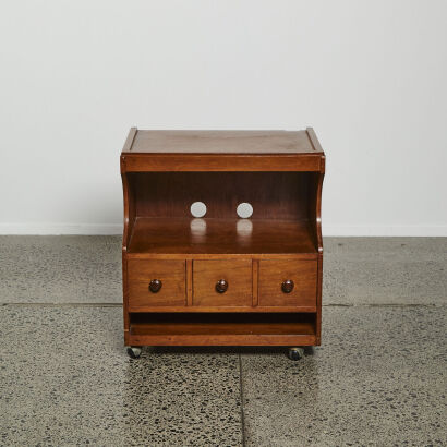 A 1950s Wooden Storage Unit On Metal Castors