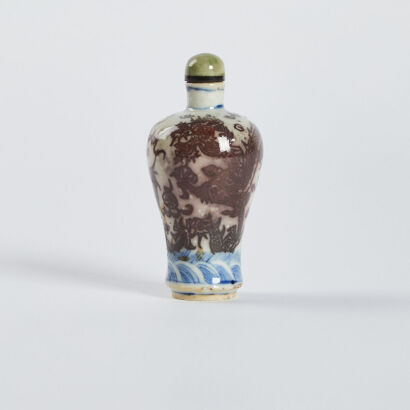 A Chinese Qing Dynasty underglaze-blue and copper-red dragon snuff bottle