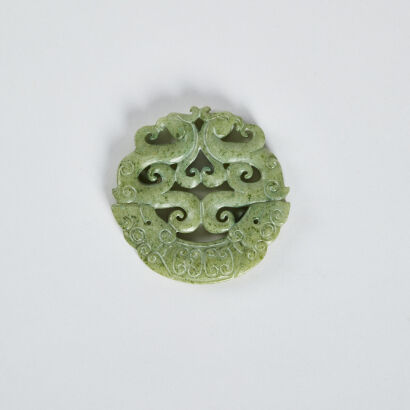 A Chinese green jade 'double phoenix' circular pendant