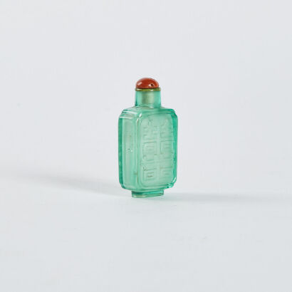 A Chinese light green glass snuff bottle carved with happy pattern