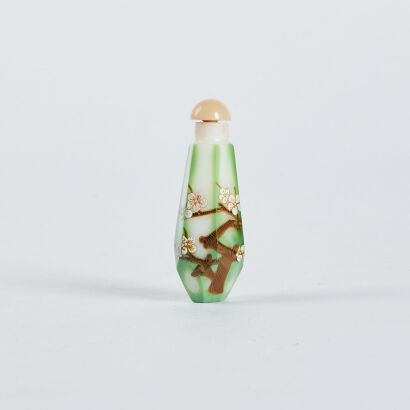 A Chinese white and green ground glass enamelled plum blossom snuff bottle