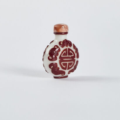 A Chinese white ground with red-overlayed carved snuff bottle with Chinese Character' wufushou'