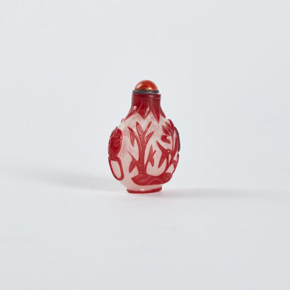 A Chinese flying snow-covered red overlay carved snuff bottle