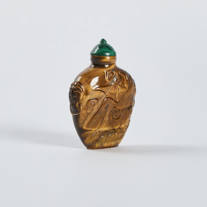 A Chinese 'tiger's eye' stone carved snuff bottle with cranes and clouds pattern