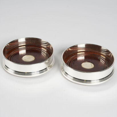 A Pair Of Sterling Silver Bottle Coasters With Walnut Bases By Broadway And Co Birmingham