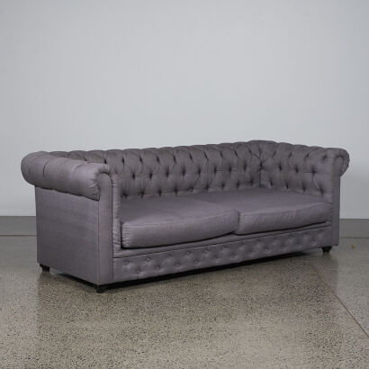 A Grey Buttoned Back Couch