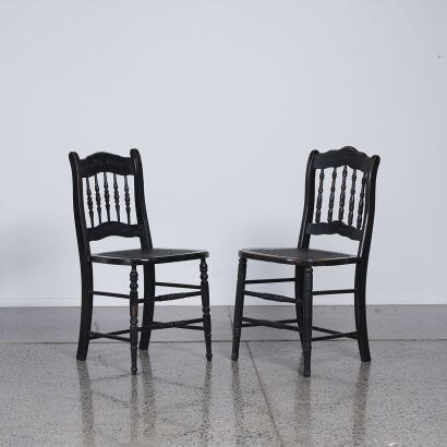 A Pair Of Antique Chairs In Black With Cane Seating