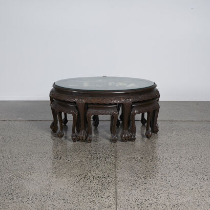 A Chinese Glass Topped Table With Intricate Inlay And Six Stools
