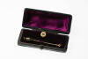 A gold and diamond stick pin. The antique pin converting to a shirt stud. 15ct rose gold. Weight 4.83 grams. Boxed.