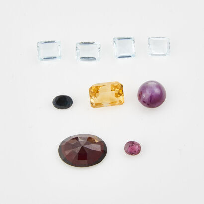 A Collection of Nine Loose Gemstones, Oval, Garnet, Citrine, Star Ruby, Aquamarine, And Sapphires