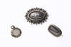 A Victorian sterling silver brooch and a rolled gold mourning locket and brooch, both with hair inserts. Length of silver brooch 4cm.