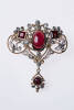 A Victorian garnet and diamond brooch/pendant, the oval cabachon garnet, two square cut and one round surrounded by 32 old rose cut diamonds in rubover and claw mounts. Rose gold. Length 48mm.