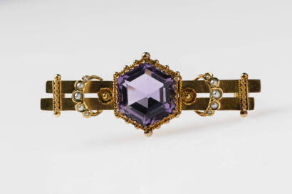 An amethyst and pearl twin bar brooch, the Edwardian style brooch set with hexagonal amethyst in a sawtooth cut mount with applied pearl set crescents. 15ct yellow gold. Hallmarked Chester 1913.