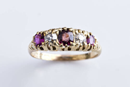 A Victorian ruby and diamond bridge ring, the three round rubies and two old cut diamonds are claw set in graduated mount. 18ct yellow gold. Weight 3.99 grams. Size P&frac12;.