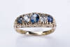 An Edwardian sapphire and diamond bridge ring, the three oval sapphires and two old cut diamonds are claw set in a scroll engraved mount. 18ct yellow gold. Weight 5.34 grams. Size N. Hallmarked Birmingham 1903.&nbsp;