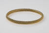 A Tiffany woven chain link bangle. 18ct yellow gold. Marked T & Co &nbsp;Weight 19.5 grams. &nbsp;Diameter 6.8cm. With original box and papers.