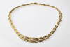 A gold neckchain the series of graduated triple rows of woven leaf design are textured with polished borders. 14ct yellow gold. &nbsp;Weight 46.97 grams. Length 45cm.