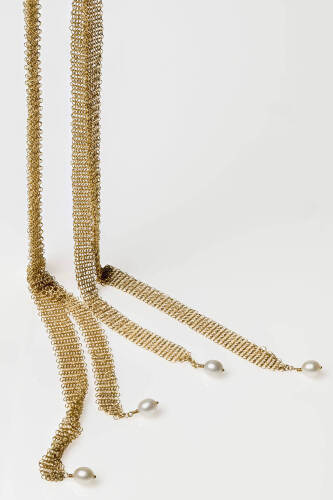 A Tiffany gold and pearl necklace, the Elsa Peretti scarf necklace of four mesh lengths with terminal cultured pearl drops. 18ct yellow gold. Weight 24.7 grams. Length 66cm.&nbsp;
