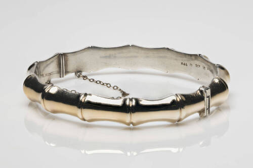 A gold bangle, bamboo design. 9ct yellow gold silver lined. Weight 13.96 grams. Inside diameter 6cm. Width 10mm. Makers mark H & S.