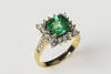 An emerald and diamond ring, the square step cut emerald of estimated weight 2.30 carats, surrounded by round brilliant diamonds of estimated weight 0.68 carats. 18ct yellow and white gold. Weight 4.6 grams. Size M.&nbsp;