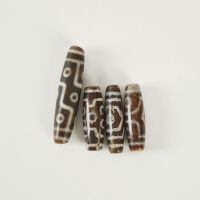 A Collection of Four Agate Dzi Beads, Tibet