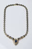 A sapphire and diamond necklace, the pear shaped sapphire of estimated weight 3.10 carats in a shield shaped centre mount with a surround of pave diamonds with two arms of open square diamond and sapphire set links. Estimated total diamond weight 1.90 car