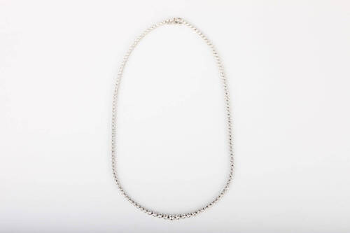 A diamond line necklace, of graduated design, set with round brilliant cut diamonds of total known weight 3 carats. 18ct white gold. Weight 16.2 grams. Length 42cm.