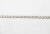 A diamond line bracelet, the thirty-four round brilliant diamonds of known total weight 5 carats. 18ct white gold. Length 17cm.