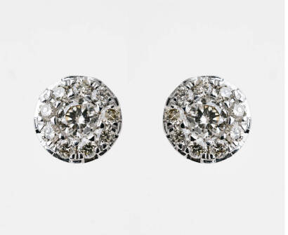 A pair of diamond stud earrings, each bezel set with a central modern brilliant cut diamond in a diamond frame. Total known diamond weight 1 carat. 9ct white gold. Weight 2.5 grams. Post attachments.