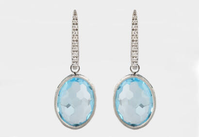 A pair of blue topaz and diamond drop earrings. 18ct white gold. Weight 7.24 grams. Length 35mm. Hook attachments.
