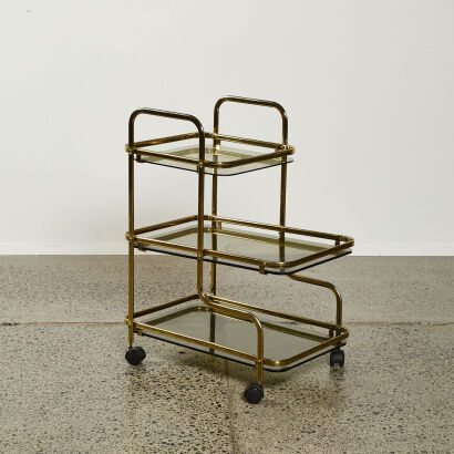 A Seventies Brass And Smoked Glass Three Tier Barcart