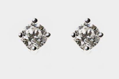 A pair of diamond earrings, the round brilliant diamonds of estimated total weight 0.30 carat set in a four claw mount .18ct white gold. Post and butterfly attachments.