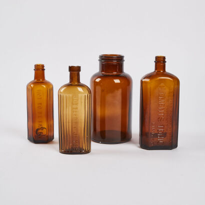 A Collection Of Four Antique Amber Bottles