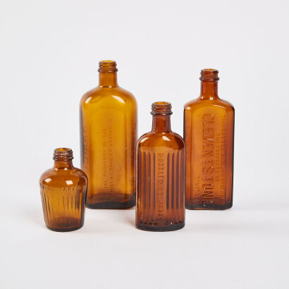 A Collection Of Four Antique Amber Bottles