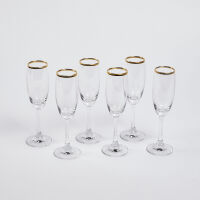 A Set Of Six Gold Rimmed Champagne Glasses