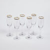 A Set Of Six Gold Rimmed Champagne Glasses