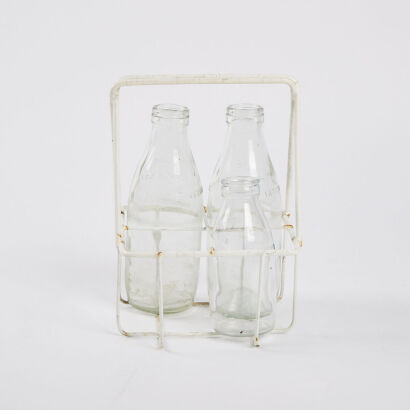 A Vintage Milk Bottle Holder With Three Milk Bottles