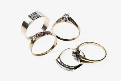 Five gold rings: Three various 9ct yellow gold rings. Weight 8.3 grams. One diamond bridge ring. 14ct white gold. Weight 2.4 grams. One 18ct yellow gold three stone diamond ring 3.6 grams.