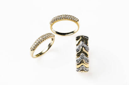 A set of three diamond rings comprising a flexible bi-tone chevron link wide band with diamonds and a pair of diamond pave set triple row bands. 18ct yellow and white gold. Weight 18.6 grams. Size L / M.&nbsp;