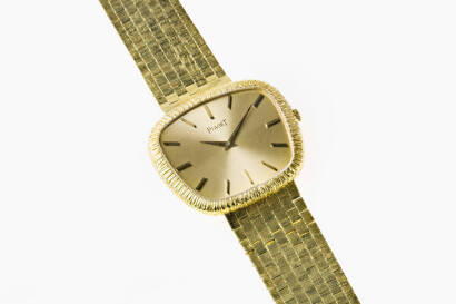 A Gentleman's gold wristwatch, Piaget. Automatic. Case number 94554 - 210782. Yellow gold dial with gold baton numerals. 18ct yellow gold case and strap.