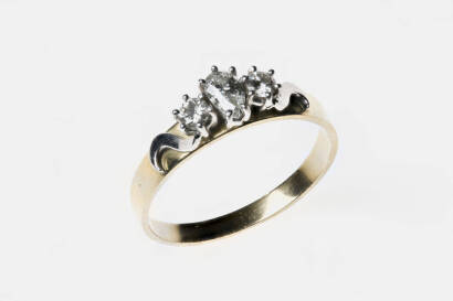 A diamond ring, set three across with one pear-shape and two brilliant cut diamonds. 18ct yellow gold. Weight 3.8 grams. Size S.