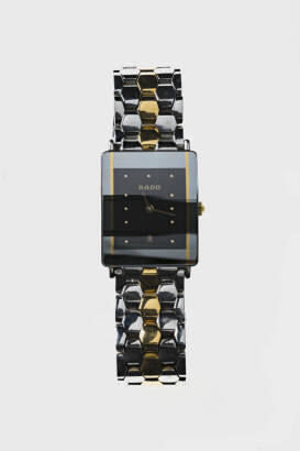 A two-tone stainless steel Dia-Star wristwatch, Rado. Quartz. 24mm. Rectangular case with black dial and date aperture at 6 o'clock. Original integral bracelet.&nbsp;