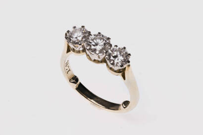 A diamond bridge ring, set three across with round brilliant cut diamonds of estimated total weight 1.30 carats. 18ct yellow gold. Weight 3.92 grams. Size I.&nbsp;