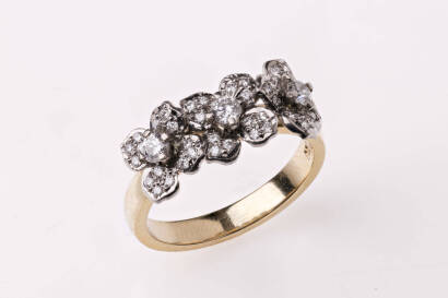 A diamond ring, with three attached white gold diamond set flowers. 18ct yellow and white gold. Weight 5.17 grams. Size K.